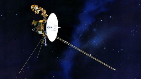 a spacecraft consisting of a large round radar dish, three long pole-like appendages extending from an octagonal body, floating in space on a starry background