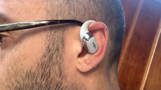 A self-photo of the author wearing the Shokz OpenFit 2 Plus earbud in his left ear.
