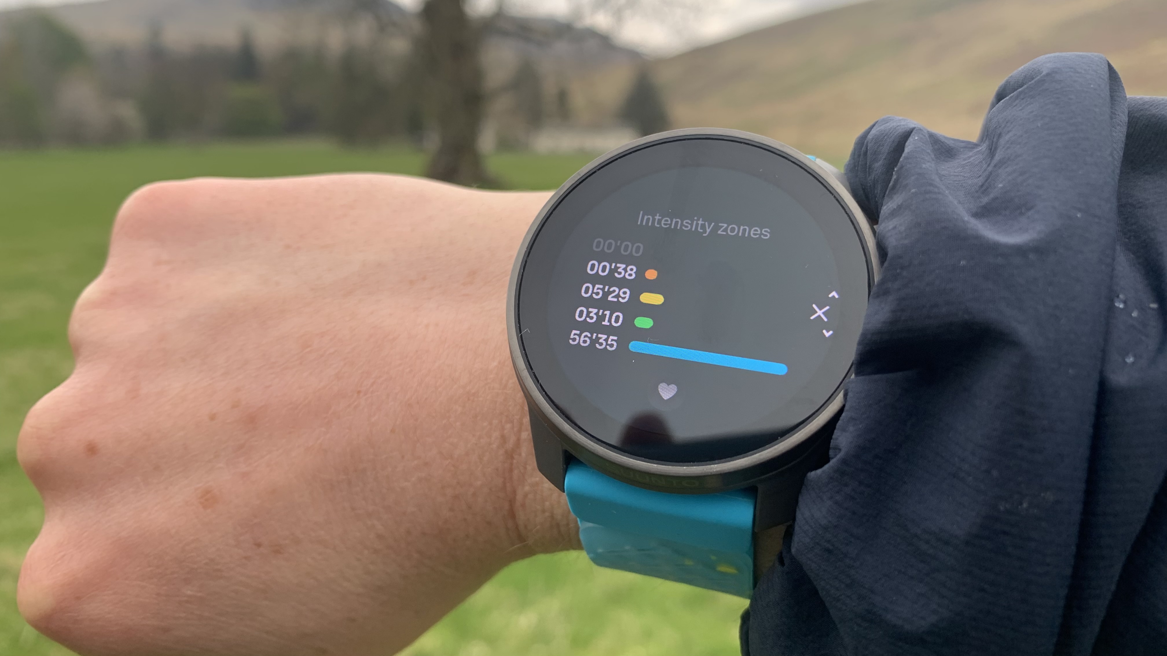 The Suunto Race S watch on wrist showing intensity zones