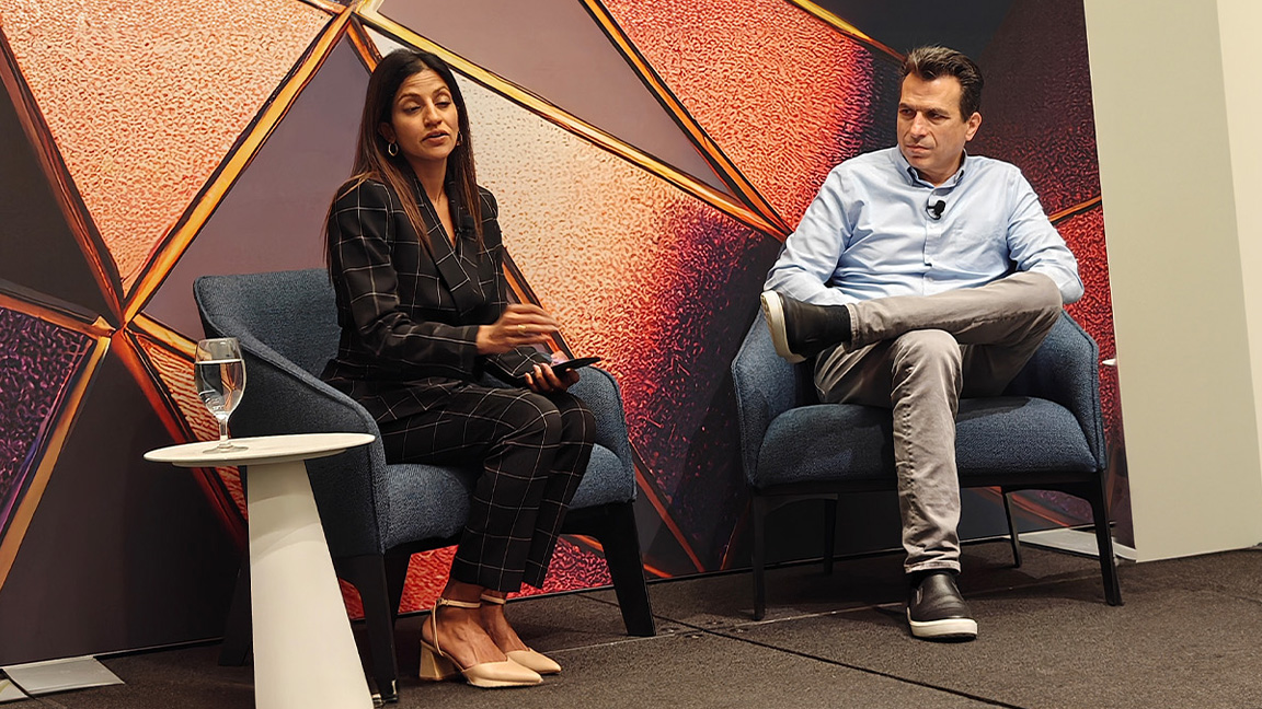 AU 2025; two people sit on a small stage and take questions
