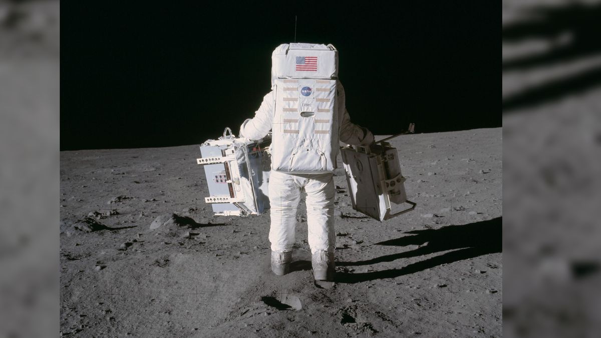 Astronaut Edwin E. Aldrin Jr., lunar module pilot, moves toward a position to deploy two components of the Early Apollo Scientific Experiments Package (EASEP) on the surface of the Moon during the Apollo 11 extravehicular activity. The Passive Seismic Experiments Package (PSEP) is in his left hand; and in his right hand is the Laser Ranging Retro-Reflector (LR3). Astronaut Neil A. Armstrong, commander, took this photograph with a 70mm lunar surface camera.