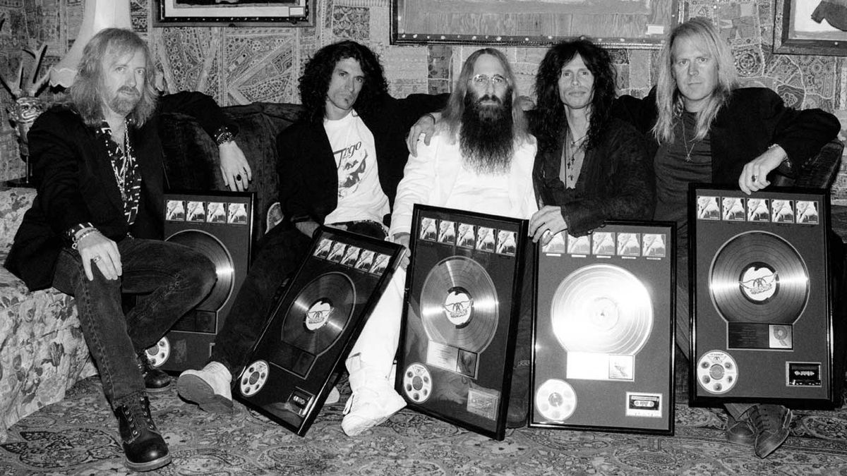 John Kalodner with Aerosmith, holding sales awards for their Get A Grip album 