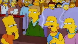 Patty and Selma talking to Bart in front of a crowd of angry people.