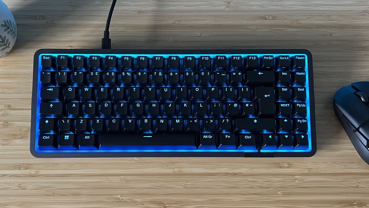 NZXT Function Elite Mini TKL on a wooden desk with mouse and plant
