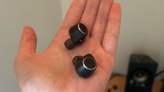 Cambridge Audio M100 earbuds in reviewer's hand