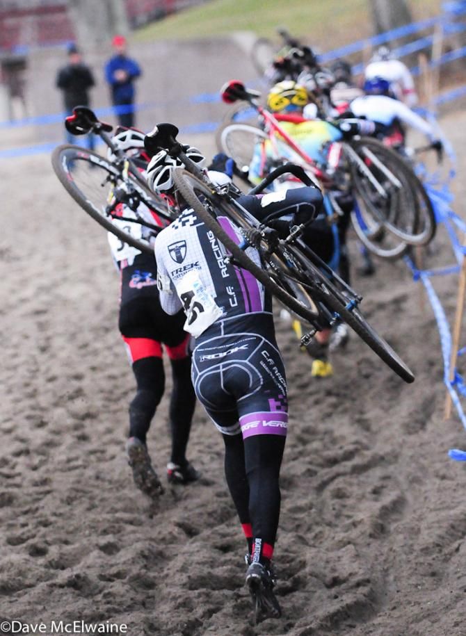 Elite men running the beach on lap two.