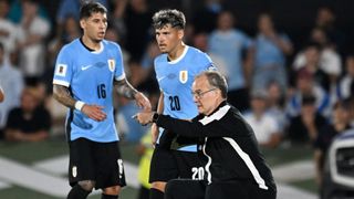 Uruguay's Argentine head coach Marcelo Bielsa (R) gives instructions during the 2026 FIFA World Cup South American qualifiers football match between Uruguay and Argentina at the Centenario stadium in Montevideo, on March 21, 2025.