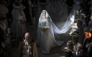 Meghan Markle wears a long white wedding dress and veil