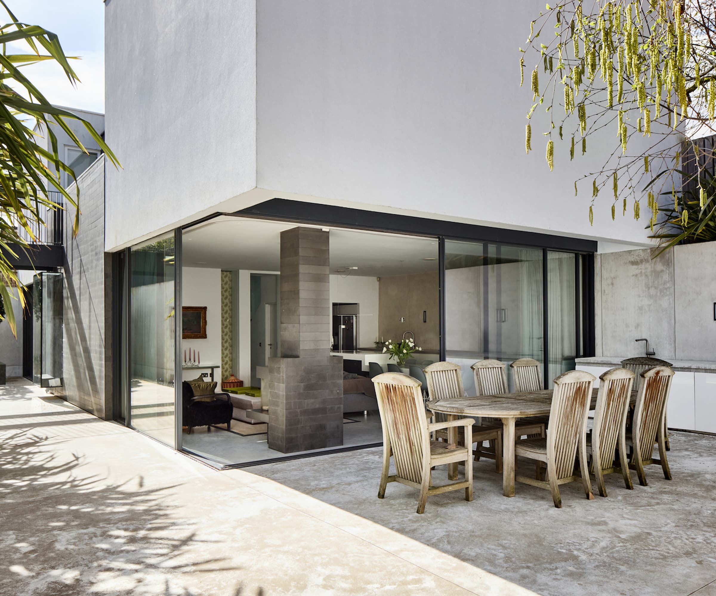 A kitchen dining area leading to an outside kitchen area and concrete area