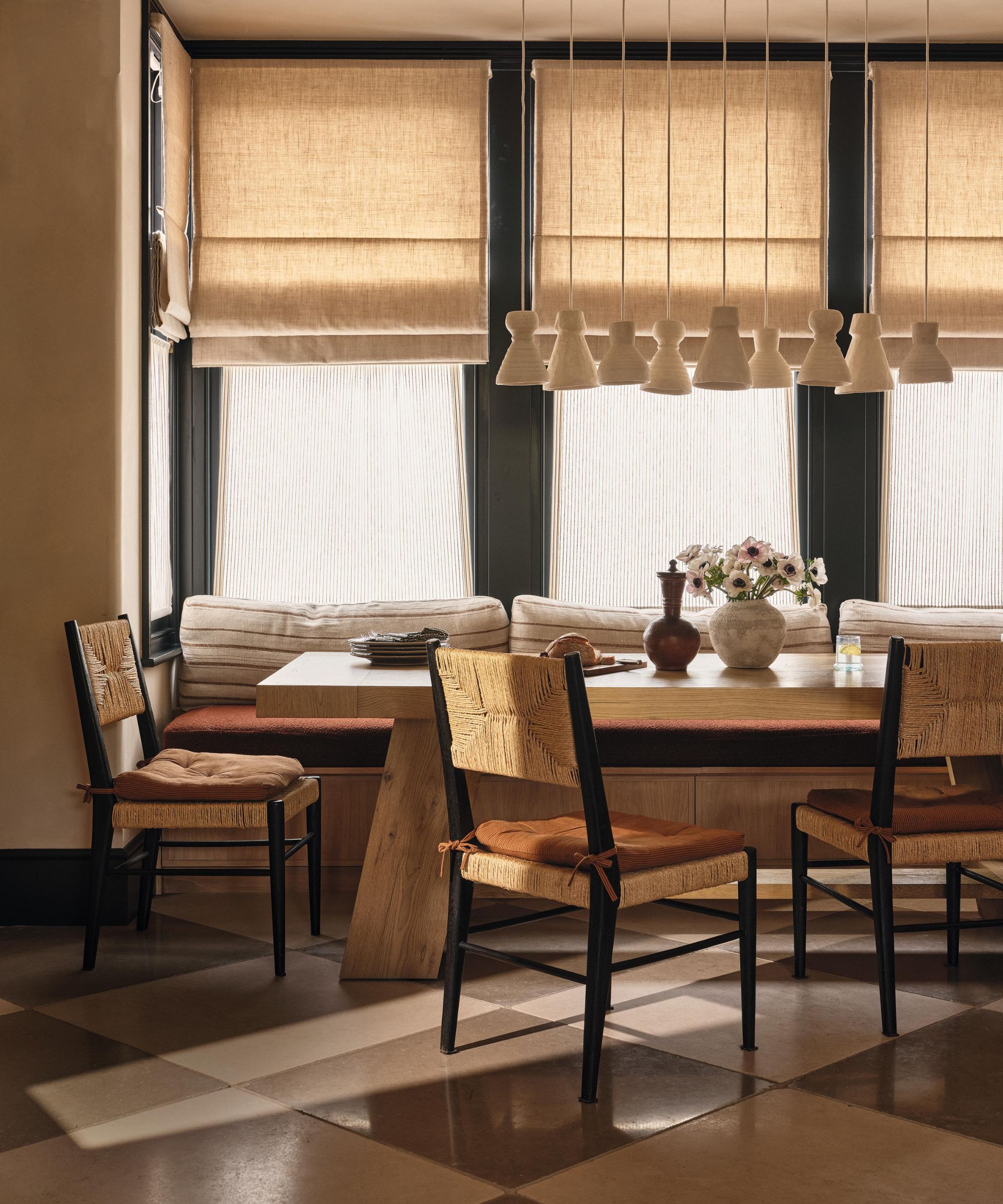 a textured cozy breakfast dining banquette area with checkerboard tiles