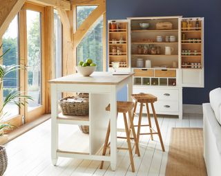 A bright, light kitchen with small, square kitchen island