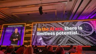 Gary Steele, GM at Splunk, live onstage at Splunk .conf24 in Caesars Forum, Las Vegas. The screen next to him says 'In the AI era, there is limitless potential'.