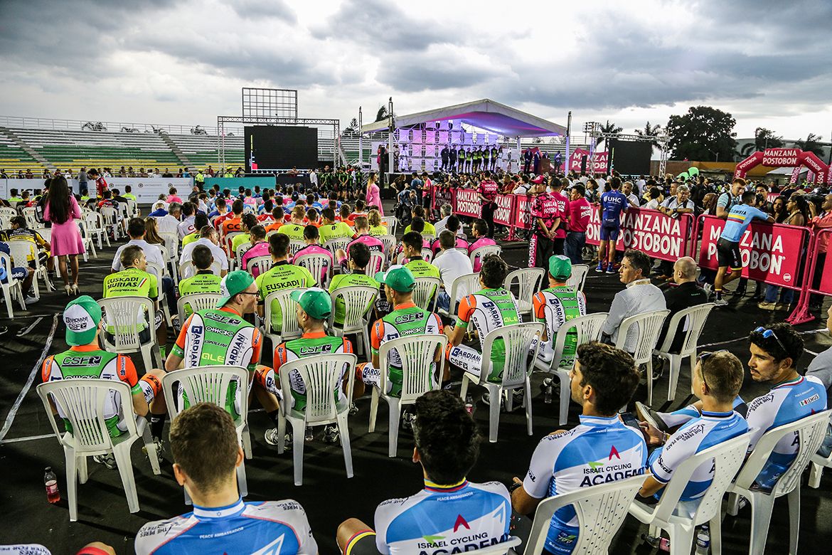 The teams watch proceedings at the Colombia Oro y Paz presentation at the Estadio Francisco Rivera Escobar in Palmira.
