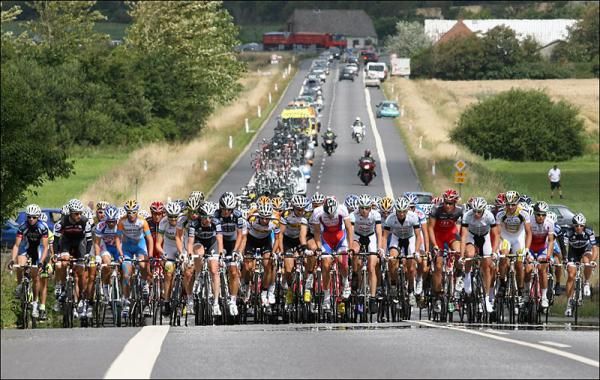 The field stretches across the road in the first day of the Tour of Denmark.