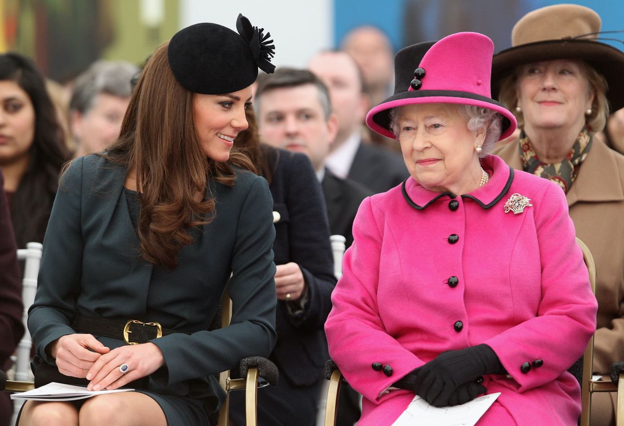 LEICESTER, ENGLAND - MARCH 08: Queen Elizabeth II (R) and Catherine, Duchess of Cambridge (L) watch a fashion show at De Montfort University on March 8, 2012 in Leicester, England. The royal visit to Leicester marks the first date of Queen Elizabeth II&#039;s Diamond Jubilee tour of the UK between March 8 and July 25, 2012. (Photo by Oli Scarff - WPA Pool / Getty Images)