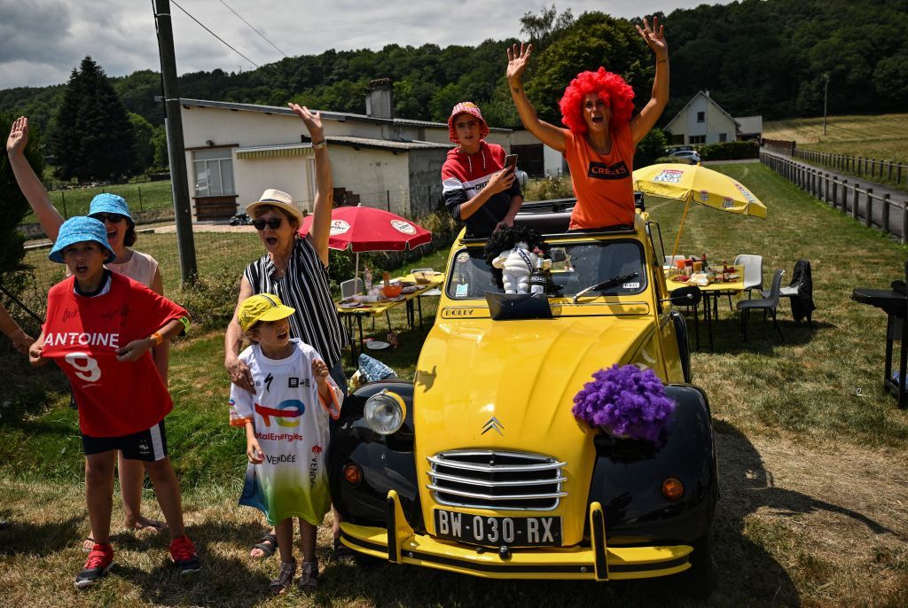 Spectators cheer by a vintage Citroen 2CV car parked along the roadside during the 17th stage of the 109th edition of the Tour de France cycling race 1297 km between SaintGaudens and Peyragudes in southwestern France on July 20 2022 Photo by Marco BERTORELLO AFP Photo by MARCO BERTORELLOAFP via Getty Images