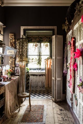 Walk in closet with shutter doors and accessories on show