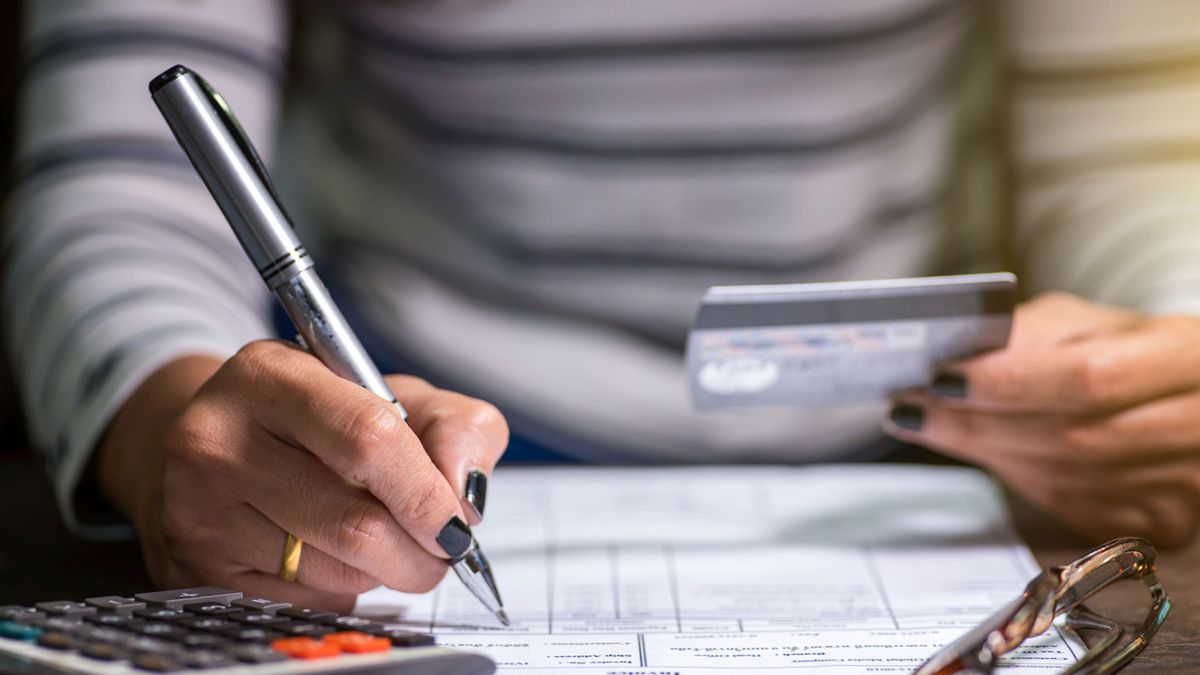 What is zombie debt: image shows woman&#039;s hand and bills