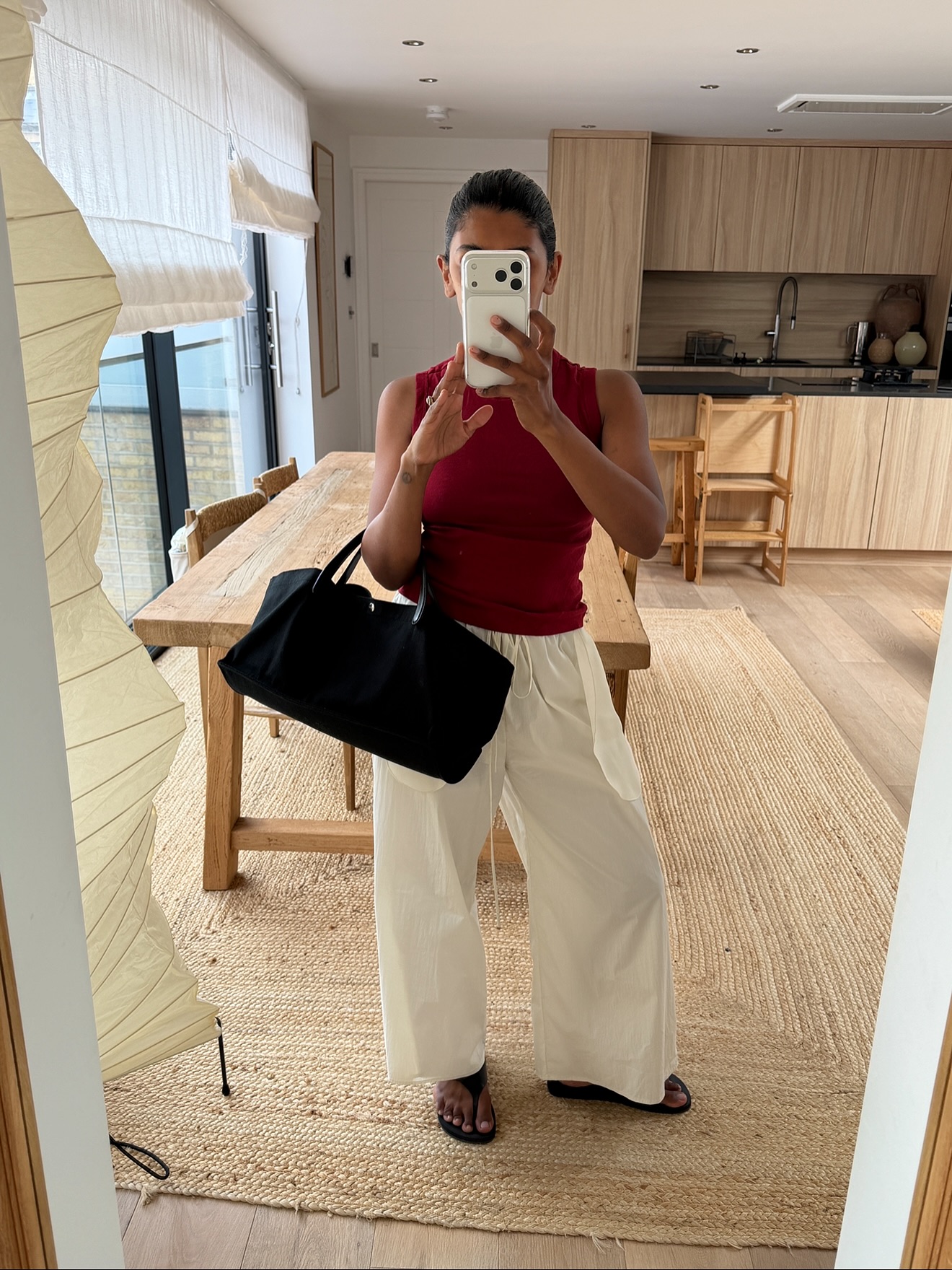 Monikh in red top and white trousers