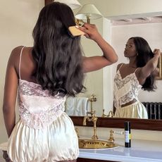 emmanuelle in pajamas with a hair brush