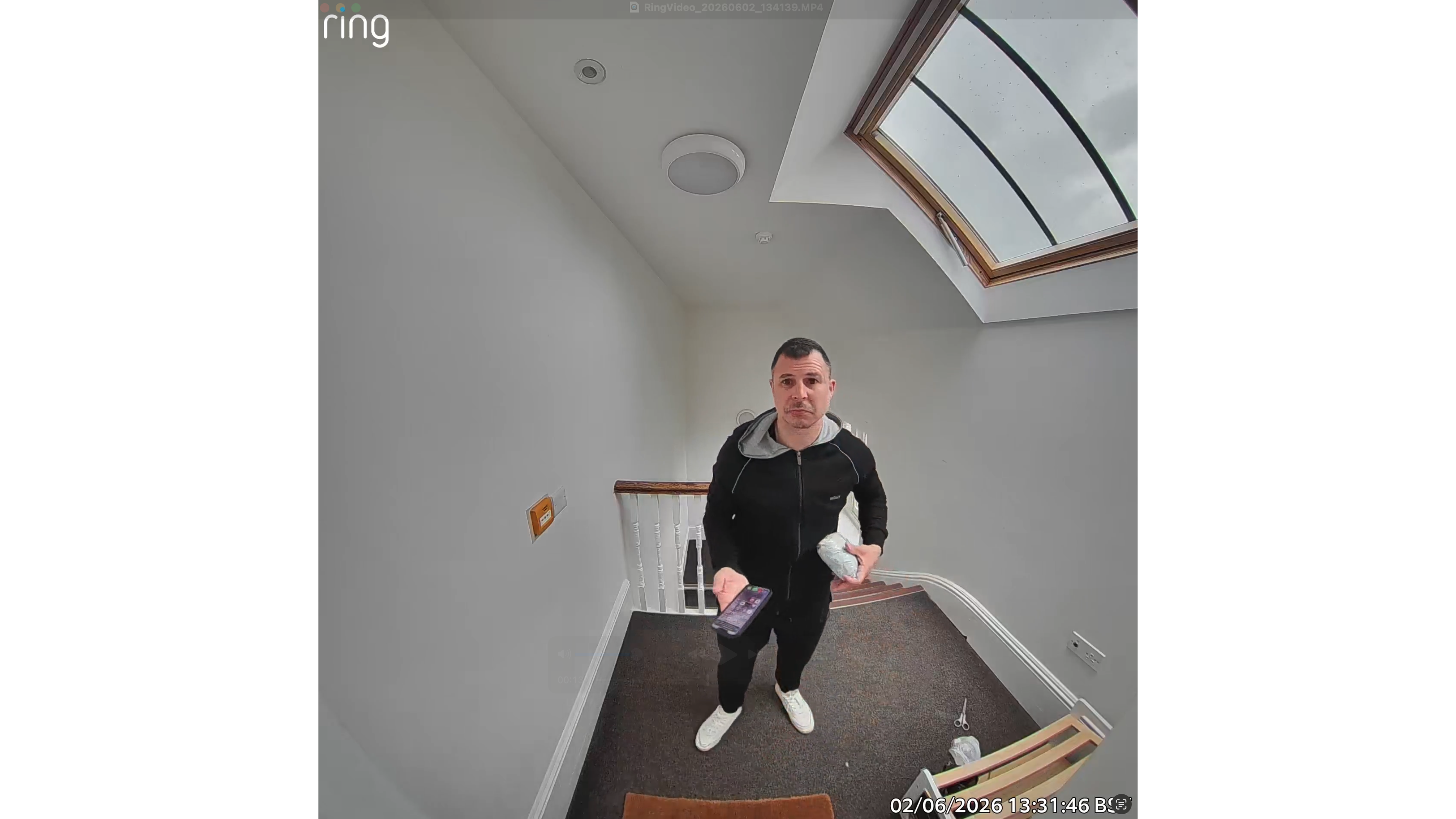 Still image of man holding package and phone, captured by Ring Battery Video Doorbell Plus (2nd Gen)