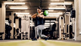 Woman performs a sandbag lunge