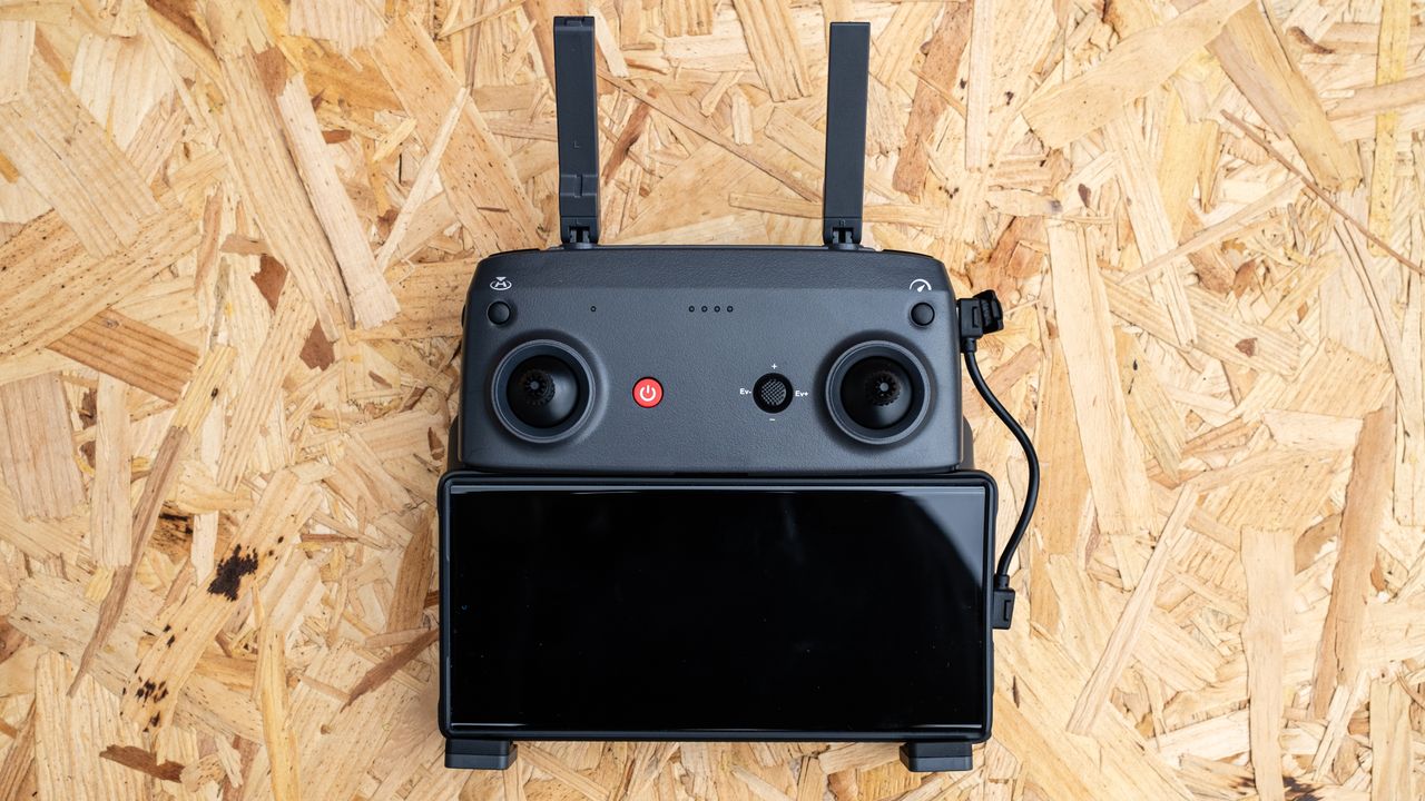 Holy Stone HS900 controller with a smartphone attached on a wooden surface