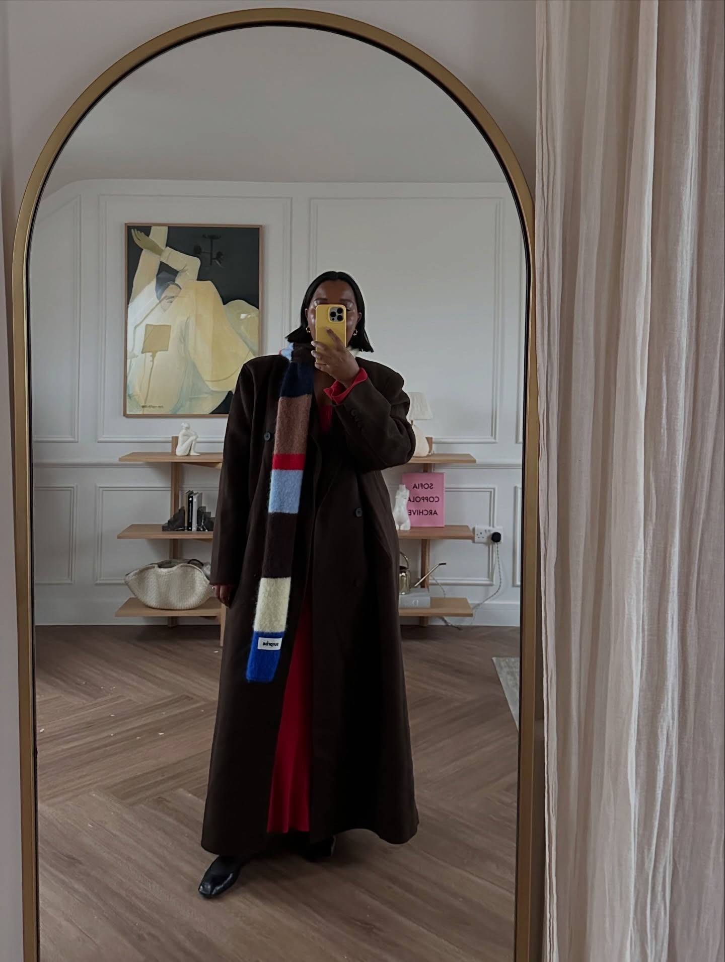 Fashion person Karina @styleidealist wears a London spring capsule wardrobe 2026 piece. She wears a thin scarf.