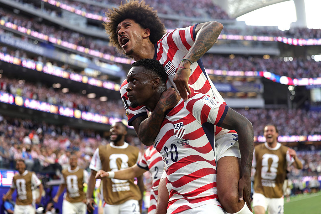 LOS ANGELES, CALIFORNIA - JUNE 12: Folarin Balogun #20 of the United States celebrates with teammates after scoring the team's third goal during the FIFA World Cup 2026 Group D match between USA and Paraguay at Los Angeles Stadium on June 12, 2026 in Los Angeles, California. (Photo by John Dorton/USSF/Getty Images)