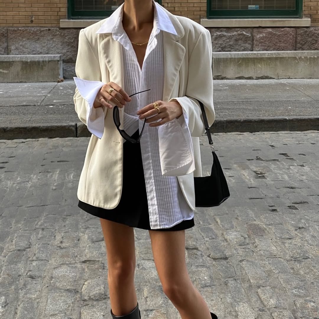 woman wearing white button-down shirt and black mini skirt summer 2025