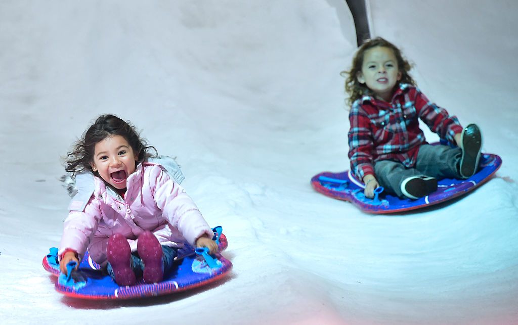 Young children enjoy the rides in Penny&amp;#039;s Snow Place at Winterfest, southern California&amp;#039;s newest wintertime experience