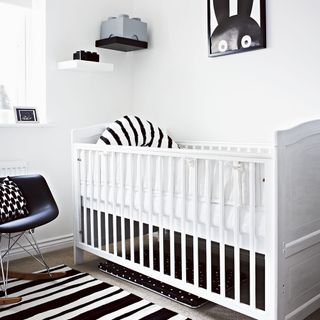 children bedroom with black and white rug and baby cradle