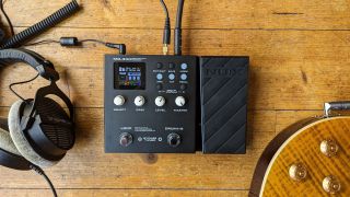 The NUX MG-300 multi-effects pedal on a wooden floor