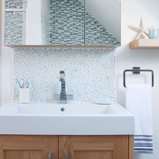 bathroom with mosaic tiles and towel
