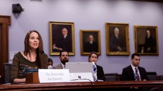 Jen Easterly, director of the Cybersecurity and Infrastructure Security Agency, testifies before a House Homeland Security Subcommittee. She is sat at a committee table with three people sat behind her and portraits on the wall in the background.