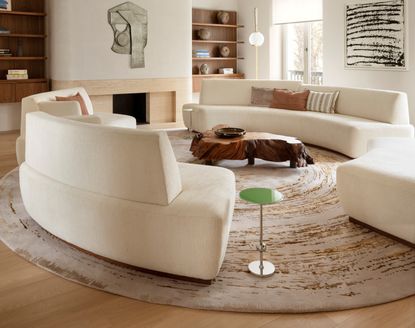 A round rug with a round curved sofa