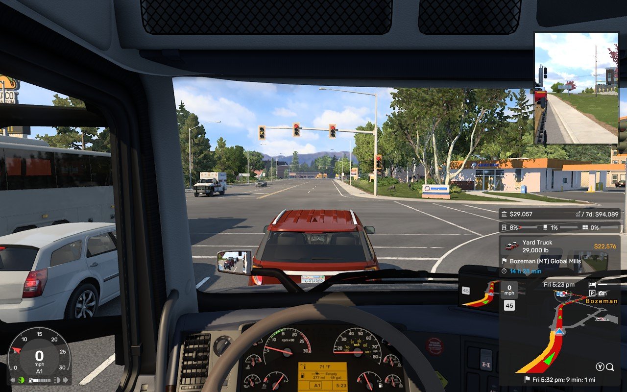 A screenshot from American Truck Simulator played on a Steam Deck showing an in-cab view from a 2014 Volvo VNL truck at a set of traffic lights.