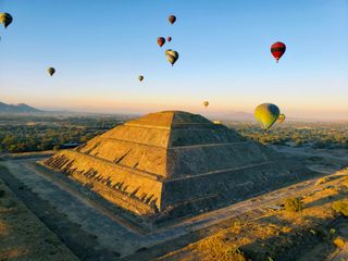 Hot air balloons in the sky flying above Teotihuacan in Mexico