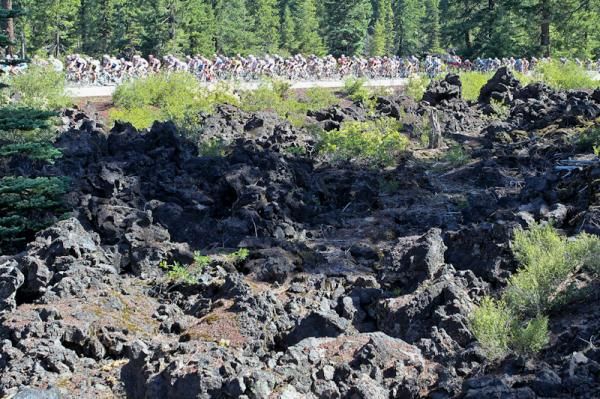The peloton pass a huge lava field as things get started for the day.