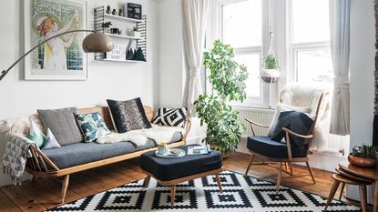 Mid-century living room with wooden framed sofa, ottoman and armchair