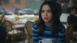 Sofia Carson sitting at a cafe table in The Life List