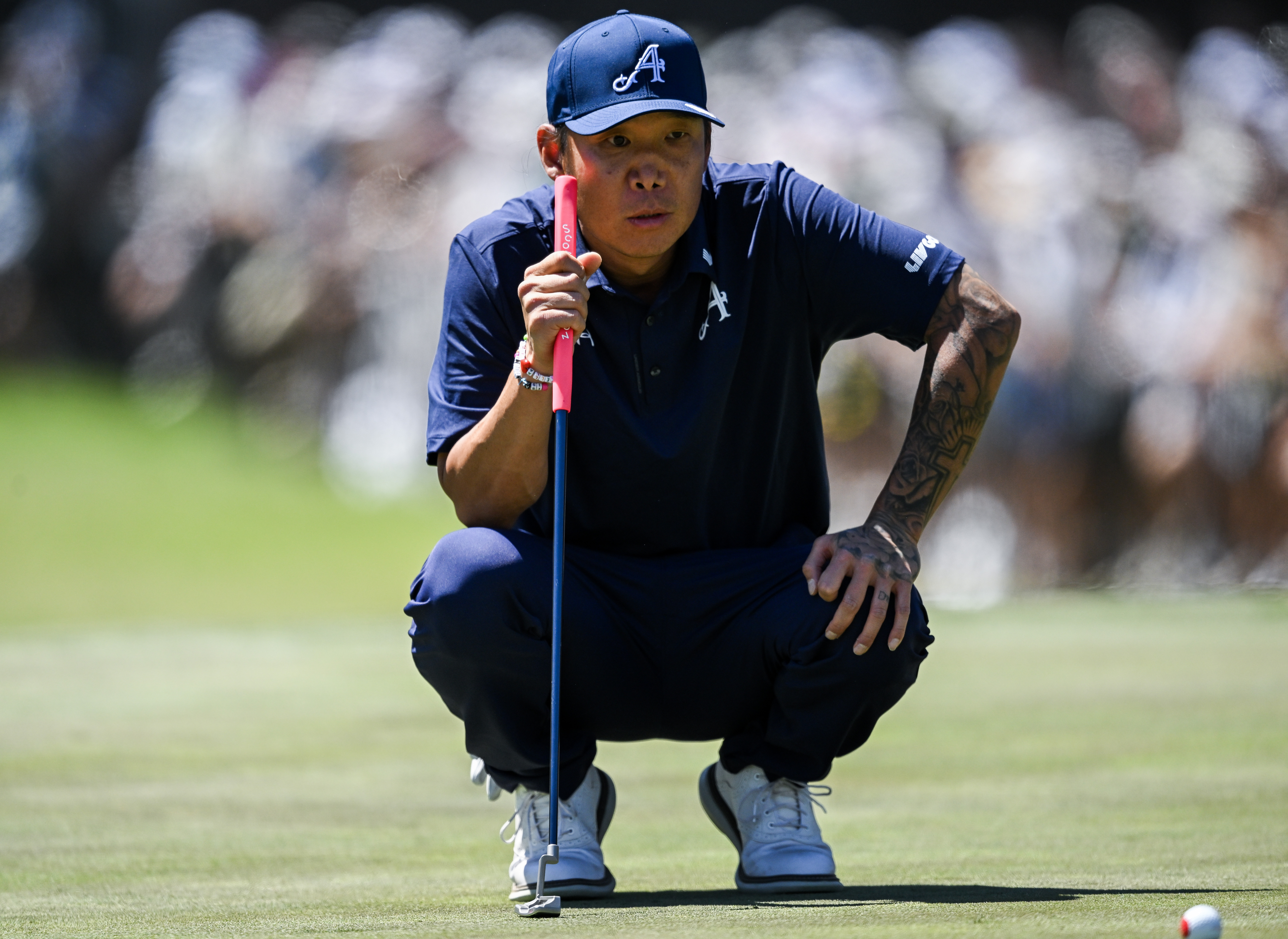 Anthony Kim lines up a putt