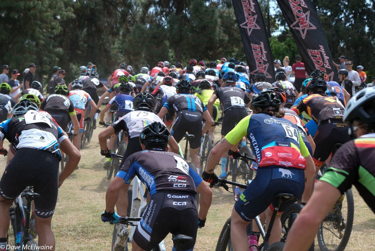 The Pro Men head onto the initial paved section of a starting loop