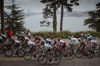 The peloton heads out of San Francisco in view of the iconic Golden Gate Bridge