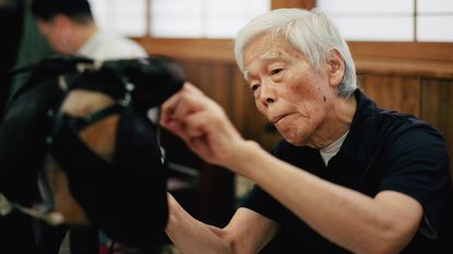 Japanese wigmaker, practising traditional Japanese hair art