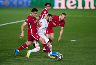 Karim Benzema of Real Madrid competes for the ball with Ozan Kabak of Liverpool