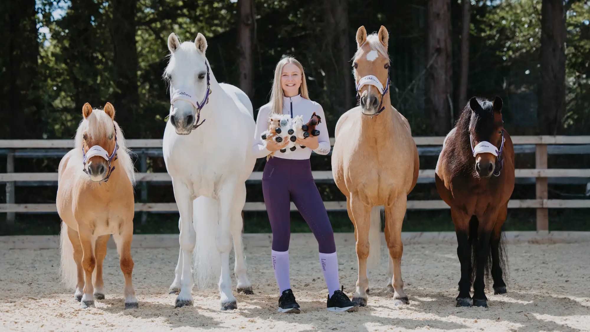 Harlow Luna White with her four real-life ponies and matching merch beanies