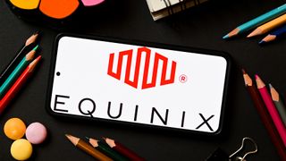 Equinix logo and branding displayed on a smartphone screen with stationary pictured in background.