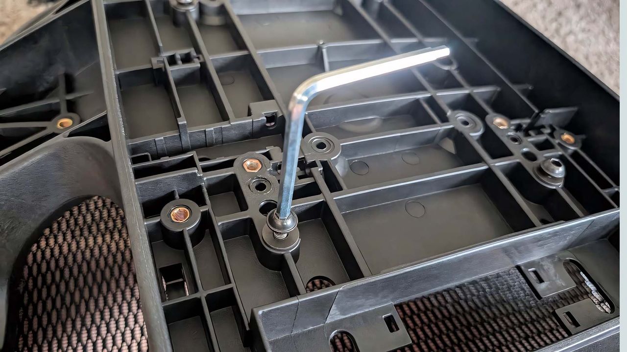 Hex key sticking out of a screw on the underside of the AndaSeat X-Air Pro Mesh Office Chair.