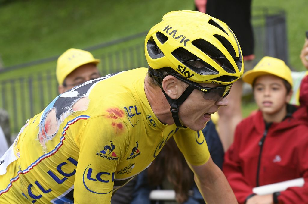 A bloody Chris Froome approaches the finish line on stage 19 after his crash